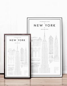 the new york city skyline is displayed in front of a chair and bookshelf