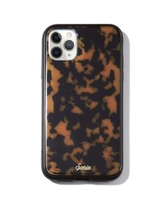 an iphone case is shown on a white surface, with brown and black spots in the background