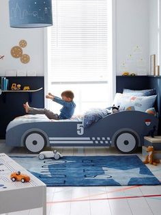 a child's bedroom with a toy car bed