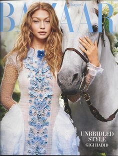 a beautiful woman standing next to a white horse on the cover of harper harper magazine