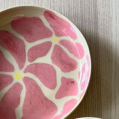 two bowls with pink flowers painted on them