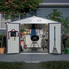 a garage with two doors open and tools in the shed on the ground next to it