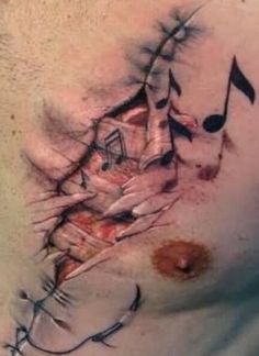 a man's chest with music notes and musical notes painted on the top of his chest