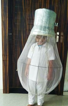 a little boy wearing a plastic hat and white pants with a net covering it's head