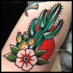 a cactus and flower tattoo on the thigh