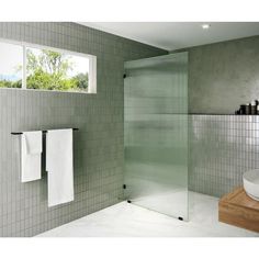 a white sink sitting next to a walk in shower