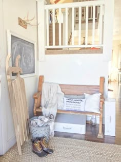 a wooden bench sitting in the middle of a living room next to a chalkboard