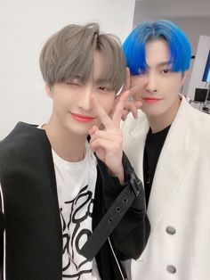 two young men with blue hair posing for the camera