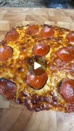 a pepperoni pizza sitting on top of a wooden cutting board