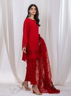 Stand out in this elegant outfit, meticulously crafted from a remarkably glamourous shade of red with its intricate hand-crafted details, with intricate embroidery on the dupatta intertwines with the fabric, forming floral motifs strikes the perfect balance between elegant and eye-catching, making this beautiful design a must have. Shirt: Self JacquardPants: Self JacquardDupatta: Organza Red Chikankari Embroidery Sharara For Designer Wear, Summer Designer Wear Red Sets, Elegant Red Sharara For Designer Wear, Elegant Red Sharara With Sheer Dupatta, Elegant Red Unstitched Suit In Chinon, Elegant Red Georgette Kurta, Elegant Red Unstitched Chinon Suit, Elegant Red Chinon Unstitched Suit, Red Lawn Suit With Sheer Dupatta For Wedding