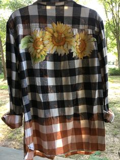 a black and white checkered shirt with sunflowers on it