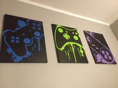 three black and purple paintings are hanging on the wall