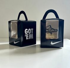 two black and white bags with nike shoes on the front one has a bag that says got'em