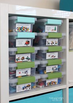 an organized toy storage unit with plastic bins filled with toys and cards for children