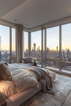 a bedroom with large windows overlooking the city