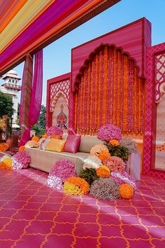 an outdoor stage decorated with flowers and decorations for a wedding or other function in india