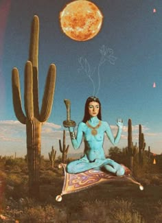 a woman sitting on top of a rug in front of a cactus and a full moon