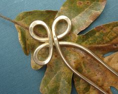 a pair of scissors sitting on top of leaves