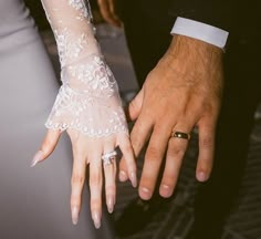 the bride and groom are holding hands together