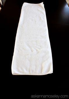 a white towel sitting on top of a black table