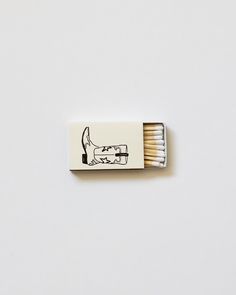 a matchbox with matches in it on a white surface