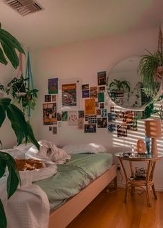 a bed sitting in a bedroom next to a table with a mirror on top of it