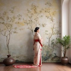 a woman standing in front of a wall with a painting on it's side