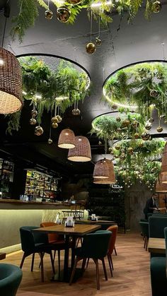 a restaurant with plants hanging from the ceiling