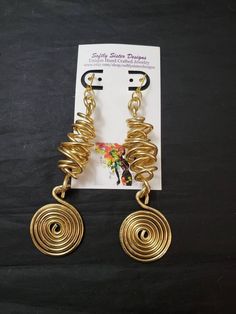 "Beautiful gold colored aluminum wire wrapped earrings are a totally unique abstract design and are 5\" inches long with gold plated leverback earwires. Please come back and visit to check for new unique designs. For more styles visit my Etsy shop: www.etsy.com/shop/SoftlySisterDesigns" Juneteenth Earrings, Copper Wire Earrings, African Inspired Jewelry, Afrocentric Earrings, Wire Jewelry Earrings, Body Decor, Queens Jewels, Diy Jewelry Display, Aluminum Jewelry