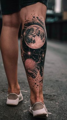 a woman's legs with tattoos on them and an image of the moon in the sky