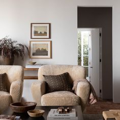 a living room with two chairs and a coffee table