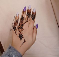 a woman's hand with flowers and leaves painted on it