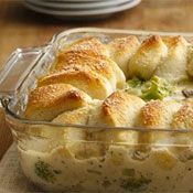 a casserole dish filled with broccoli and bread croissants