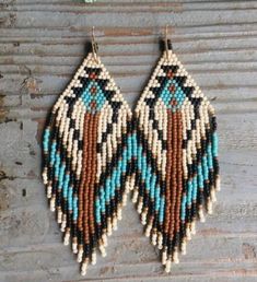 two pairs of beaded earrings hanging on a wall