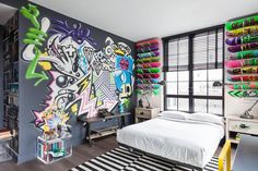 a bedroom with graffiti on the wall and floor