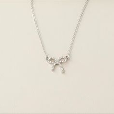 This Posting Is For One Silver Colored Bow Necklace. Very Timeless Piece Of Jewelry. Super Cute For An Adult Or Young Woman. Wonderful Costume Piece Of Jewelry For Your Collection. Condition: Brand New Color: Silver Fast And Careful Shipping! Prom Jewlrey Looks Silver, Dainty Silver Rhinestone Necklace For Party, Dainty Rhinestone Choker For Party, Dainty Rhinestone Necklace With Clavicle Chain For Parties, Dainty Rhinestone Clavicle Necklace For Parties, Delicate Cubic Zirconia Necklace For Party, Dainty Rhinestone Necklace With Adjustable Chain For Party, Dainty Clavicle Chain Bridal Necklace For Party, Dainty Bridal Clavicle Chain Necklace For Party