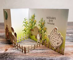 a handmade greeting card with an image of a chicken and a house on it