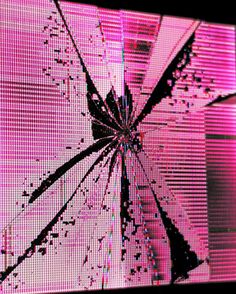 an image of a broken screen with pink light coming through it and the background is blurry