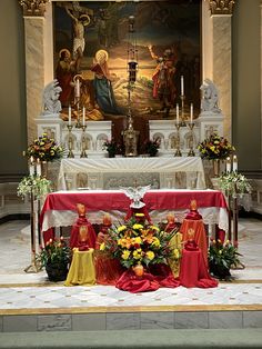 the altar is decorated with flowers and candles