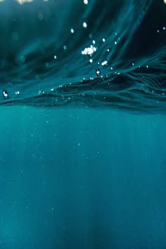 the water is very clear and blue with little bubbles