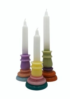 four candles with different colors and sizes