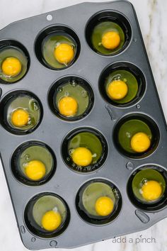 eggs are being cooked in a muffin tin