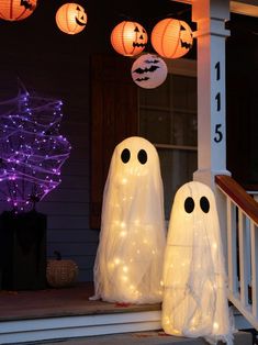 two lighted ghost decorations on the front porch