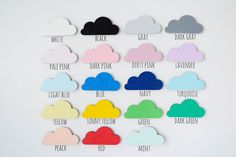 there are many different colors of clouds on the wall with words above them that read, white, pink, blue, yellow, green, black, gray, and dark pink