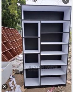 an empty bookcase is sitting on the ground