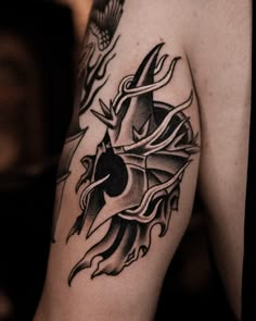 a black and white tattoo on the arm of a man with an arrow in it