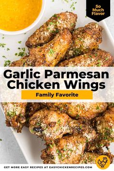 garlic parmesan chicken wings on a white platter with a bowl of sauce