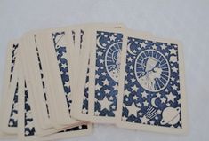 four blue and white playing cards sitting on top of each other