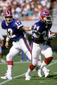 two football players are running on the field