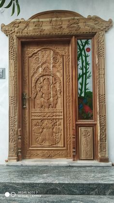 an ornate wooden door with stained glass in the window